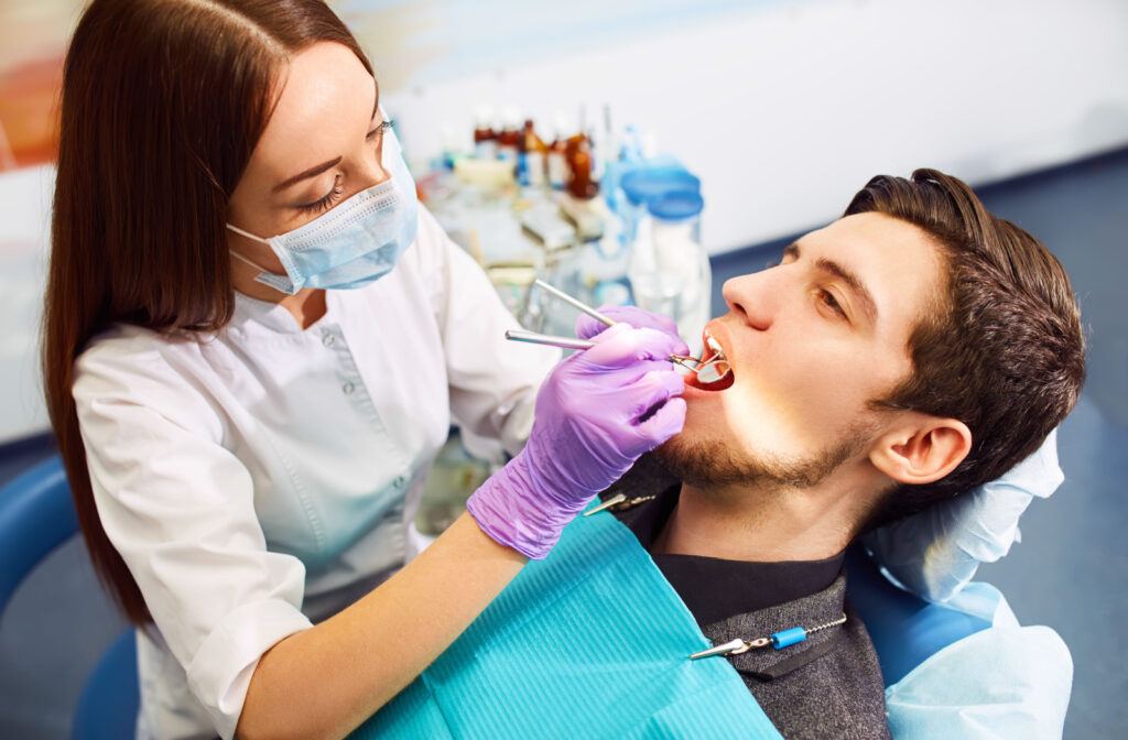 Dentist looking for cavities on a patient's teeth