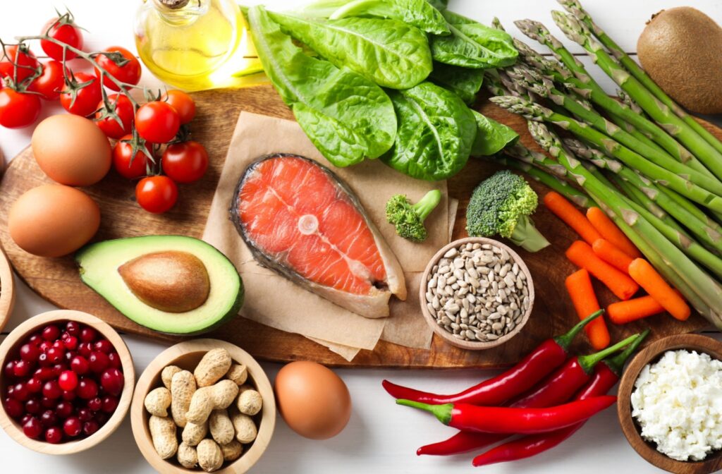 A variety of healthy foods including salmon, avocado, peanuts, spinach, and more.